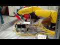 Robotic CD unpackage and drive load/unload