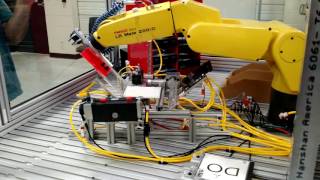 Robotic CD unpackage and drive load/unload