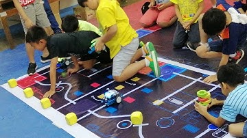 Kids testing their mBlock code designed to stop when detecting obstacle