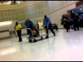 Cuffed and wheeled away like an oversized luggage.