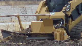 Cat 299d2 XHP Grinding down Stumps