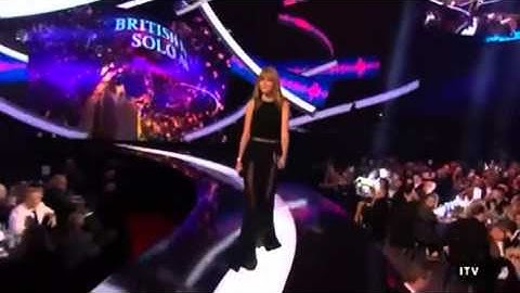 Harry Styles watches as Taylor Swift enters - BRIT Awards 2013