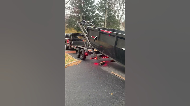 Maxx D roll off trailer pulling 14 yard dumpster