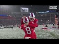 Bills players celebrate in the snow after win