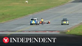 Climate activists glue themselves to runway at Hamburg Airport in Germany