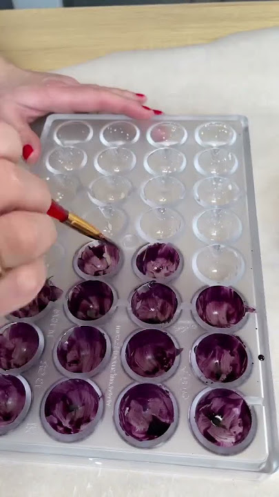 Painting bonbon moulds for chocolate