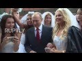 Russia: Putin mobbed by young models dressed as brides