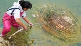 The girl pried open the mutated oyster and was surprised to find pearls the size of an egg inside