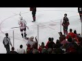 Nic Dowd casually hands Andrei Svechnikov's stick to a fan