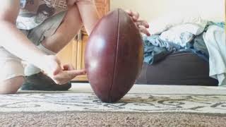 How to hold a football for a field goal.