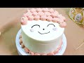 Cake of smiles incorporating image of a happy light pink curlyhaired boy into decorated cream cake