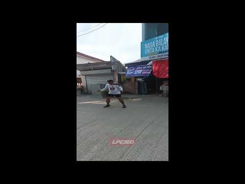 Dog runs at man dancing in street