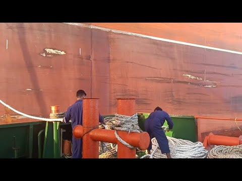 Ropes are being collected from large ships and very lightly rippled on ...