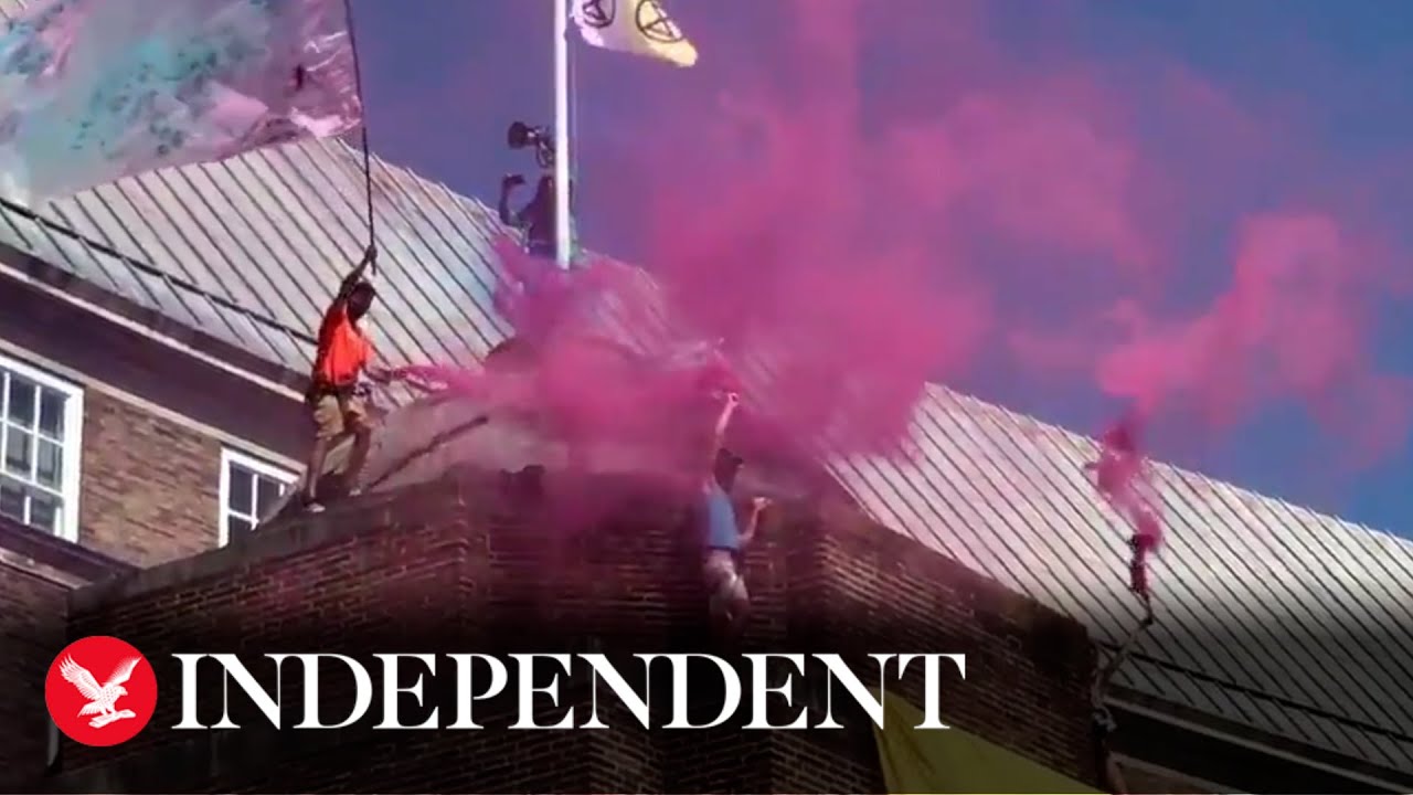 Extinction Rebellion protesters scale Bristol city hall and release smoke bombs on roof