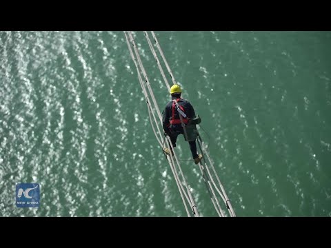 "Dancers in the clouds:" Checking power lines 100 meters above sea level in E China