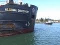 Lake boat with problems, Algoma Discovery needs assistance from Tug boat to get against wall.