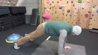Plank to knees up rock back