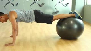 Toronto personal trainer demos swiss ball plank with toe taps