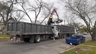 Claw truck picking up trash