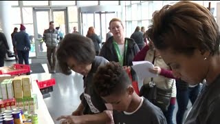Volunteers pack food for families in need