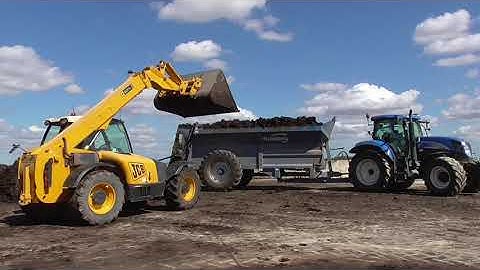 muck spreading with new holland t6080 and bunning spreader loaded by jcb telehandler