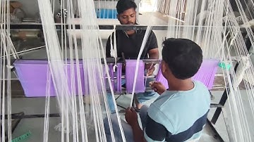 "Precision in every thread: Drawing the warp beam for flawless weaving."