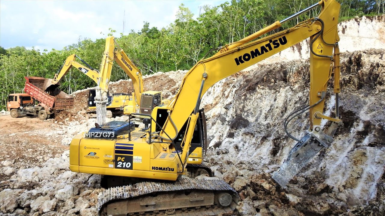 Excavators Dump Trucks Working Hard Digging A New Limestone Road - YouTube