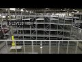 Tekno asrs pallet flow system with gravity roller conveyors and two storage  retrieval cranes