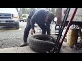 Breaking a tire bead by hand.