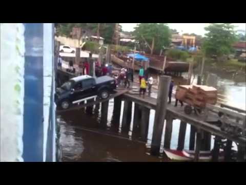 Car boarding a ship over a plank