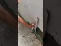 applying plaster to damaged wall surface to fix cracks and smooth the wall using putty and trowel