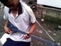 Boy Plays Homemade 2-String Guitar: Bisaya Christmas Song