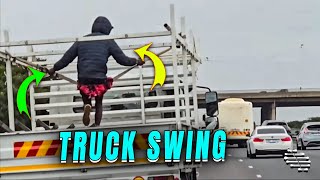 Man Swinging on the Back of a Moving Truck