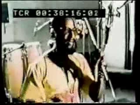 King Scratch updates his '60s rock steady hit "I am the Upsetter" at Joe Gibbs recording studio in 1982. Footage includes shots in the control room with the late great Errol Thompson at the controls, assisting Scratch as he annoints the studio with ganja during playback,