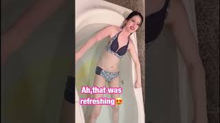 Girl pee in a bathroom with her swimsuit