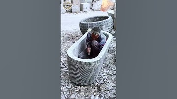 The old stonemason used a chisel to handcraft granite into a huge fish tank