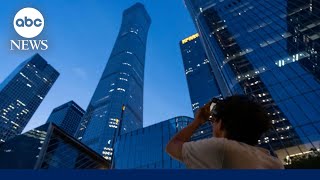 Plane slams into Beijing's tallest building, sends debris raining down onto streets