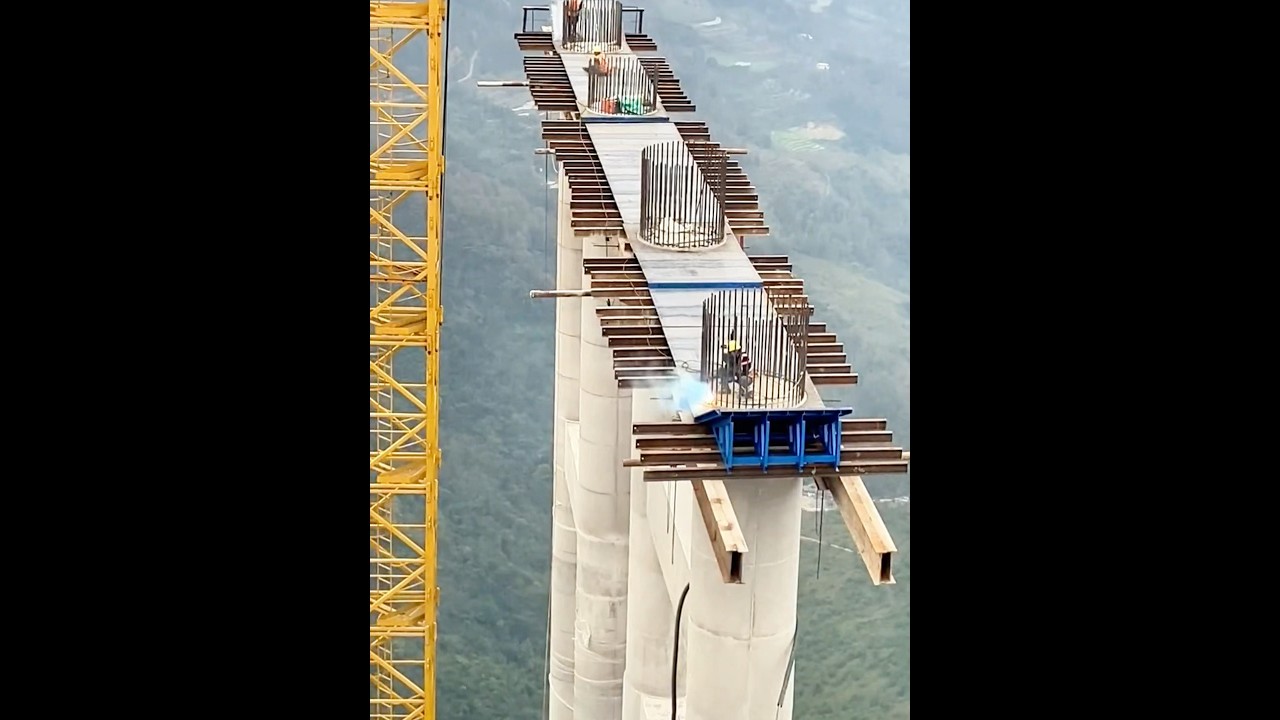 Bridge construction workers welding at a height of 100 meters. 