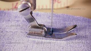 Slow motion the needle of the sewing machine makes stitches