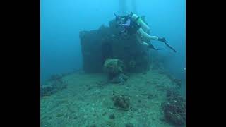 Scuba Divers Exploring Sunken Ship