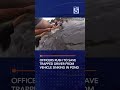 Officers rush to save trapped driver from vehicle sinking in pond
