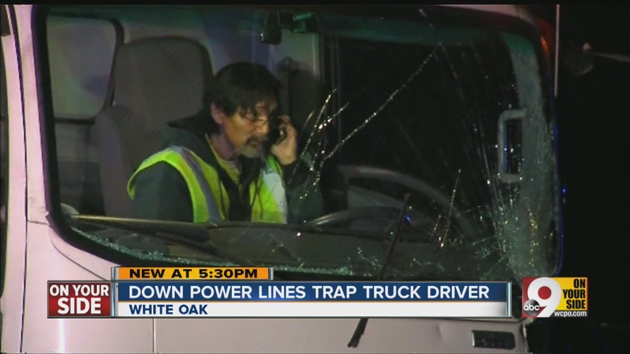 Down power lines trap truck driver - YouTube