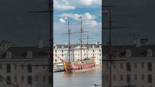 Aerial timelapse of the National Maritime Museum with the sailboat replica Amsterdam docked nearby