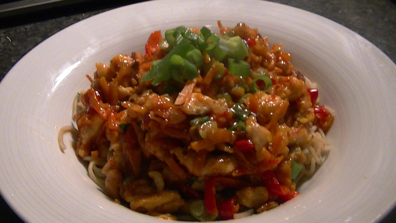 Tasty noodles with crispy chicken, vegetables and sweet chili sauce