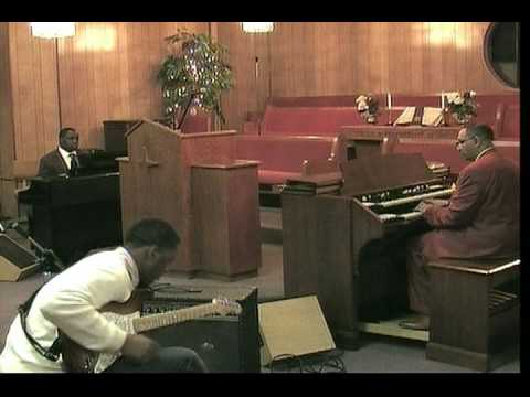 Pastor Curtis Daniel, Organist -playing 'Praise Him!'