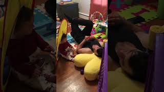 Baby Girl Laughing At Her Dad As He Plays With A Ball