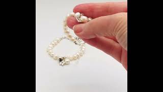 childs white pearl christening bracelet personalised with a silver letter charm and her birthstone y