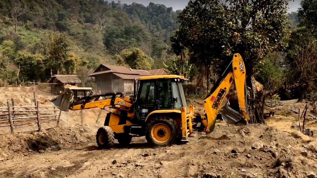 JCB Backhoe 3DX Machine Leveling Mud In Hill Land - JCB Pulling Out Stones Hilly Field