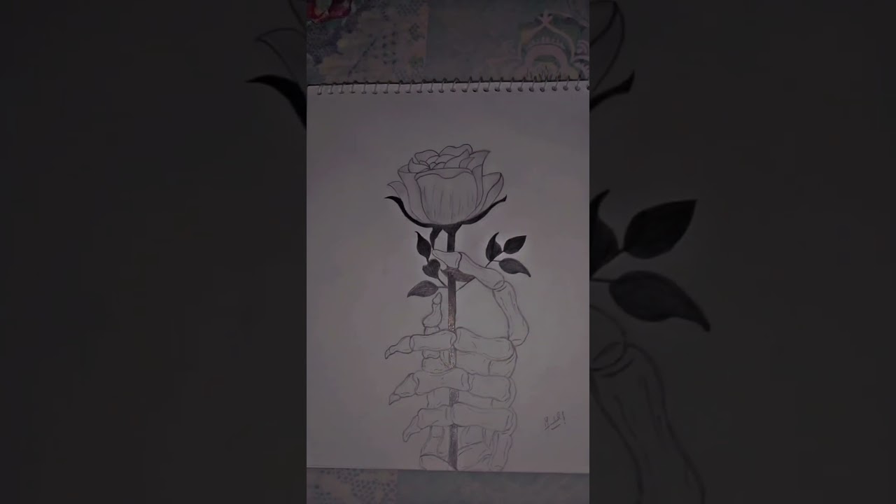 sketch of skeleton hand holding a rose