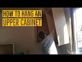 How to hang an upper cabinet on a wall that is not plumb